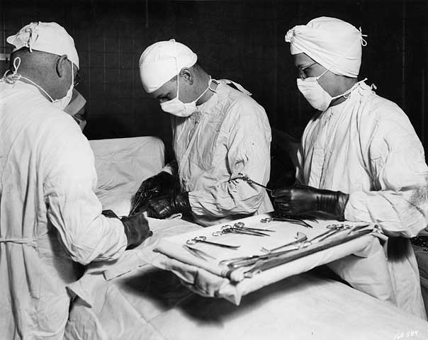 Dr. O. S. Wyatt and Tague Chisholm perform pediatric surgery, with nurse  2/12/1947